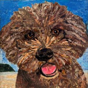 pet portrait of a brown dog at the coast